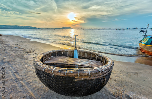 Basket boat before dawn as the sun slowly rise to express the rest of the season when fishermen fish on, languish waiting to be put to sea