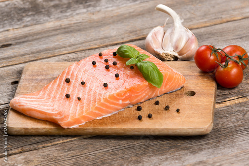 Raw salmon fillet with herbs