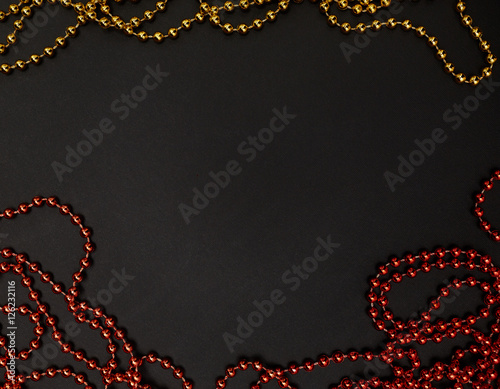 Pile of golden beads garland. Christmas beads as a background or texture. Christmas garland made from small red beads. New Year. Decor. Masquerade. Celebration. Triumph.