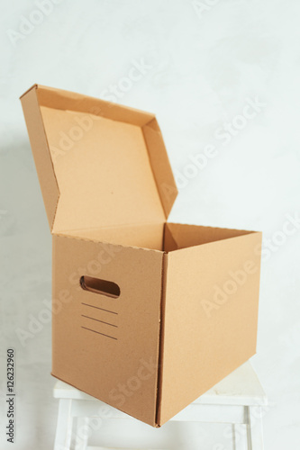 Big cardboard boxes standing insinde a room photo