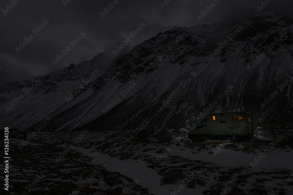 mobile home in winter weather in the moutains by night