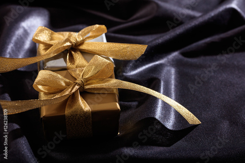 Gift boxes on a black satin background © Rawf8