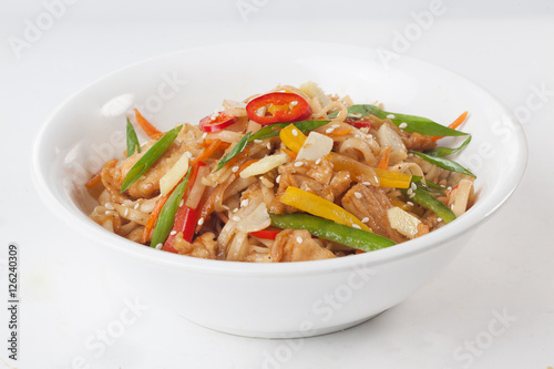 wok noodles with beef vegetables, ginger, sweet pepper on a plate isolated