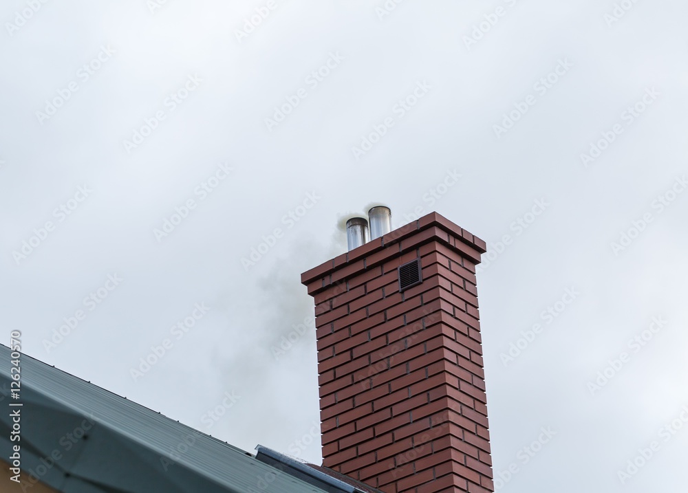 House chimney with flying smoke