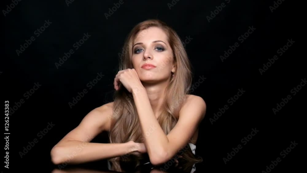 Beauty female video. Blonde woman model posing at mirror table on black background Beauty female video. Blonde woman model posing at mirror table on black background