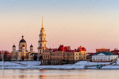 City landscape. Country Russia, Rybinsk. Embankment of the Volga River. A small town in the rays of the setting sun.