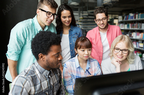 international students with computers at library