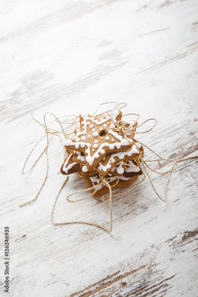 Fototapeta premium Gingerbread icing cookies with gold cord. Christmas decoration.