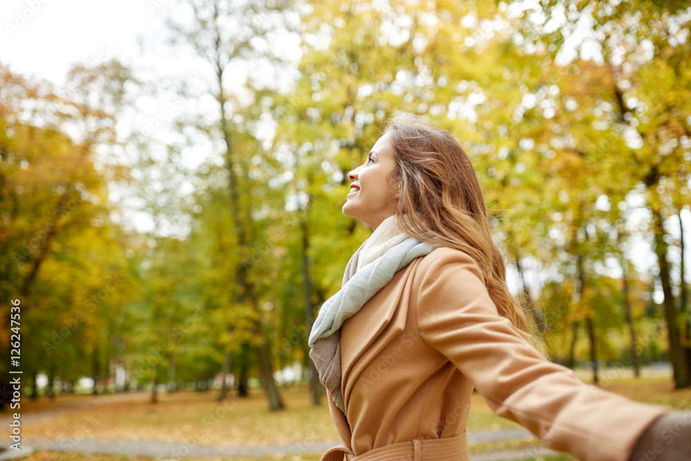 beautiful happy young woman walking in autumn park beautiful happy young woman walking in autumn park