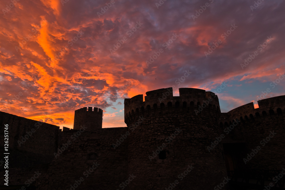 Silhouette of fortress towers of Kalemegdan fortress at dramatic colorful sunset, Belgrade, Serbia
