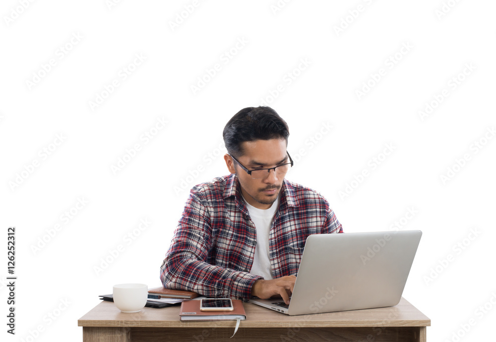 Young businessman working on laptop isolated on white background