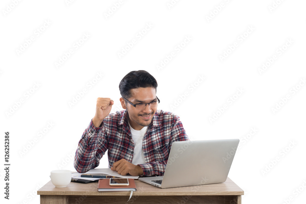Young businessman working on laptop succeed with word at workpla Young businessman working on laptop succeed with word at workpla