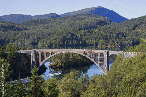Old bridge to the wooded island in the middle of the bay, Norway