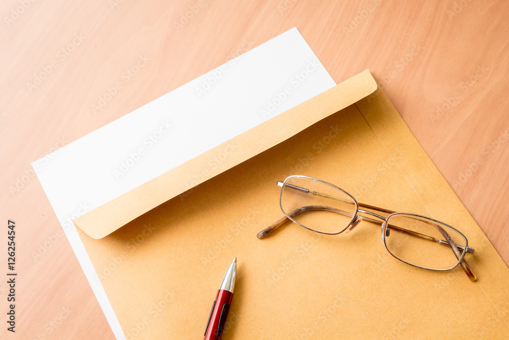 Brown envelope on wooden background Brown envelope on wooden background