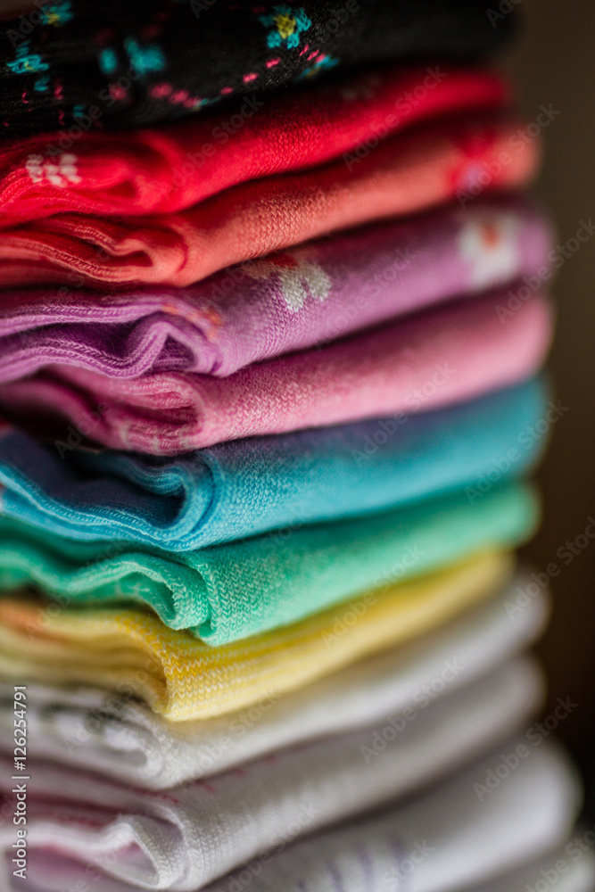 A pile of colorful clothes on white A pile of colorful clothes on white