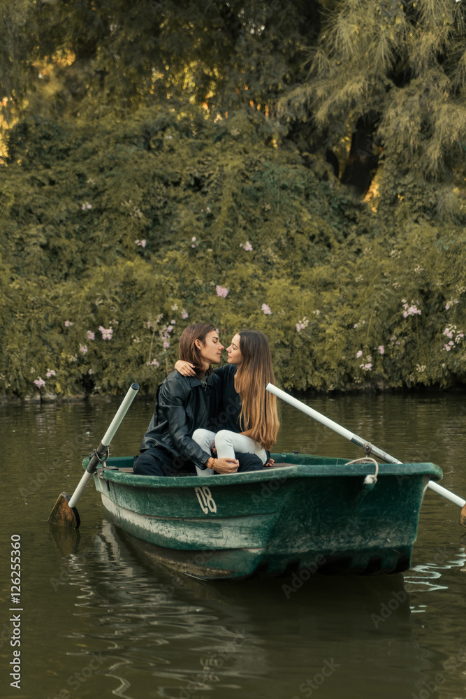 Couple embracing in boat in river. Couple embracing in boat in river.