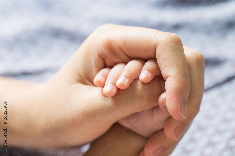 Baby hand holding finger mom. (Selected focus) Baby hand holding finger mom. (Selected focus)
