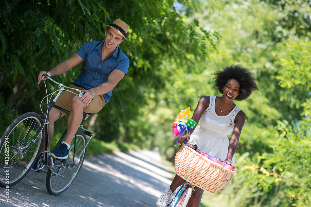 Young couple having joyful bike ride in nature Young couple having joyful bike ride in nature