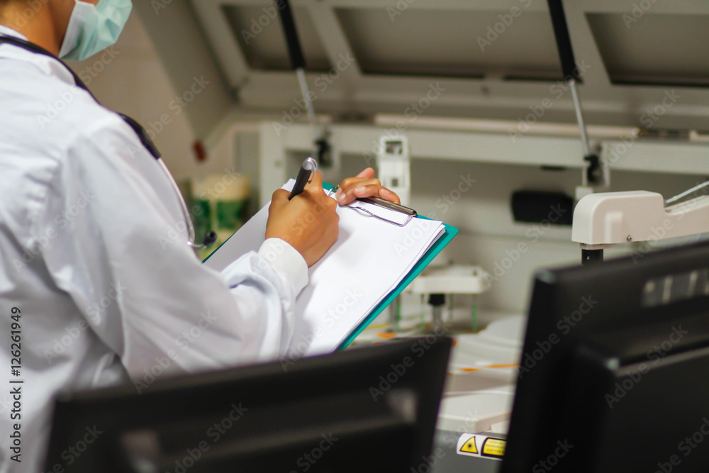 Asian female doctor writing medical report Asian female doctor writing medical report