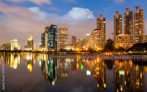 Bangkok at twilight with light and reflection, view from Benjakitti park, Bangkok Thailand