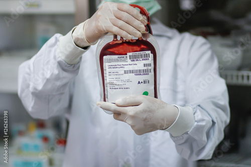 Doctor holding fresh donor blood for transfusion photo