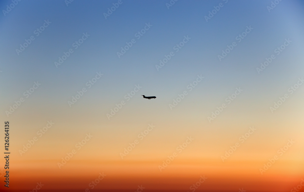 Plane in the sky at sunset/ fly/ high/ sun/