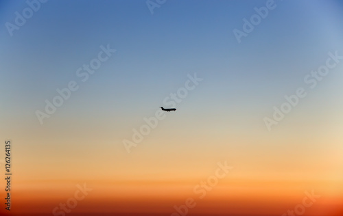 Plane in the sky at sunset/ fly/ high/ sun/