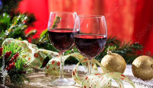 Red wine glasses on snow