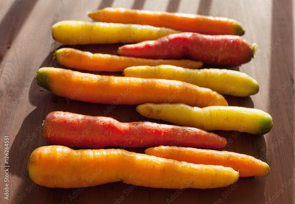 raw colorful carrot vegetable on wooden background raw colorful carrot vegetable on wooden background