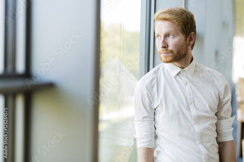 Successful businessman standing by the window