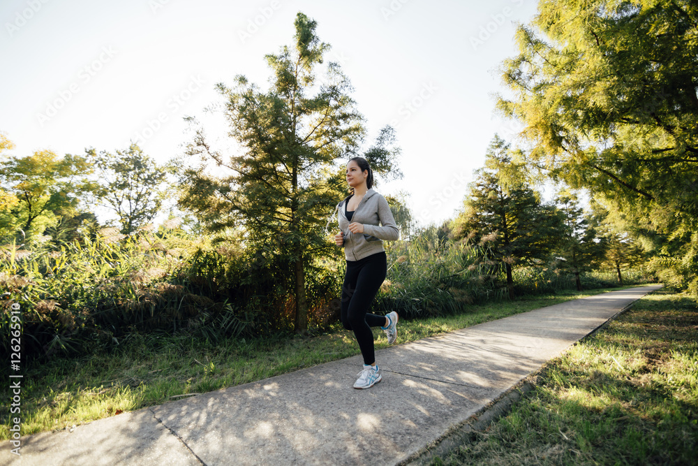 Fototapeta premium Fit beautiful woman jogging in park