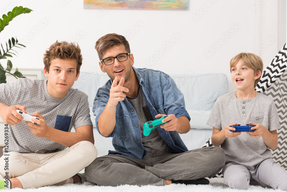Fotografie Father and sons playing together