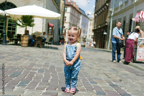 Little beautiful smiling girl showing tongue © Yuliia