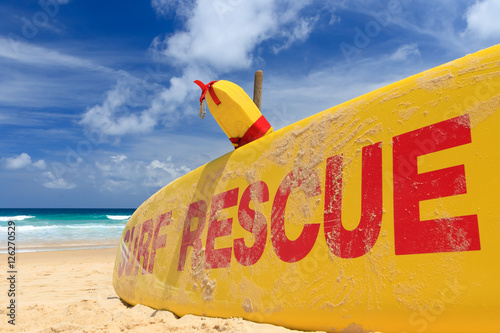 Yellow surf rescue board  by the sea beach.
