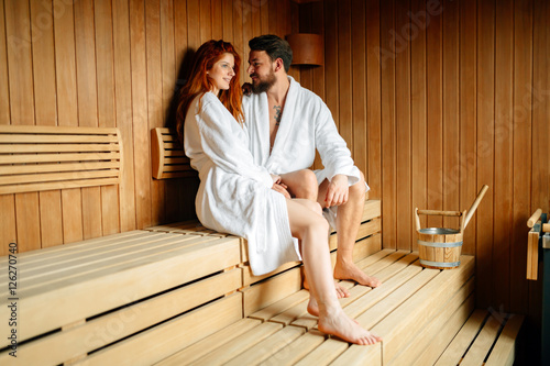Beautiful couple relaxing in sauna
