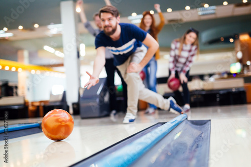 Friends having fun while bowling