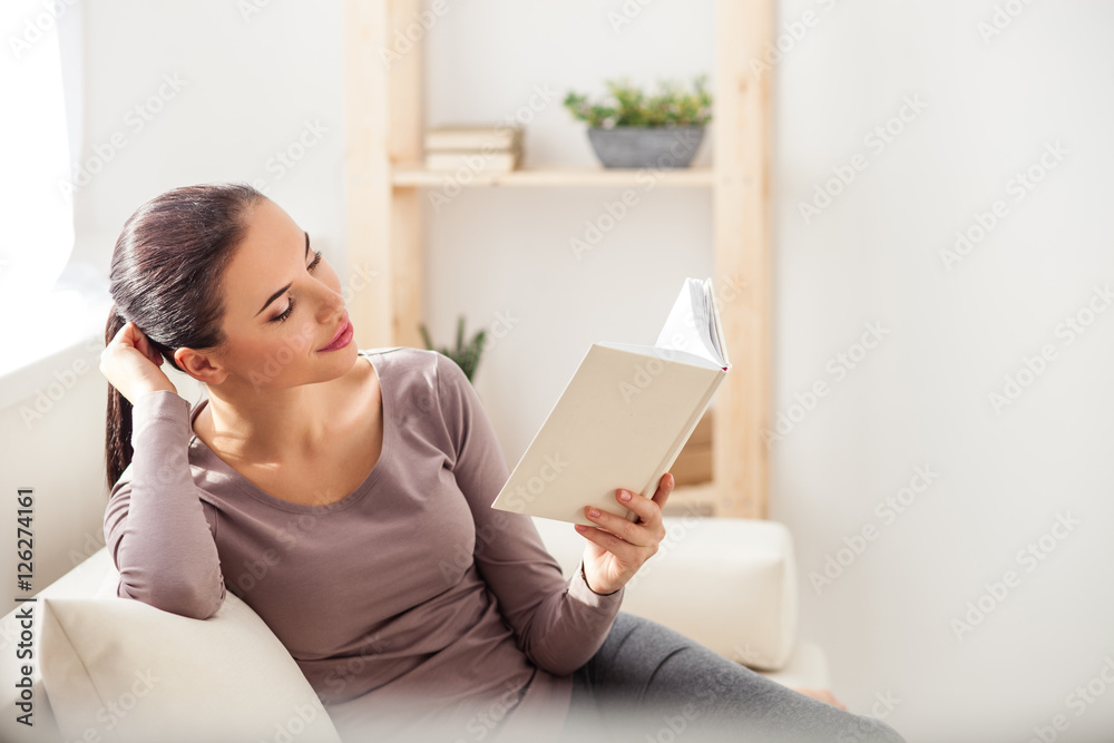 Relaxed woman entertaining with literature at home Relaxed woman entertaining with literature at home