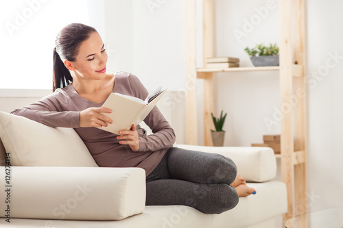 Cheerful girl resting in her apartment