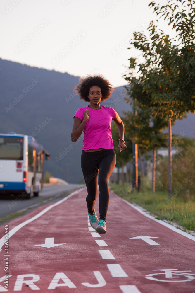 a young African American woman jogging outdoors