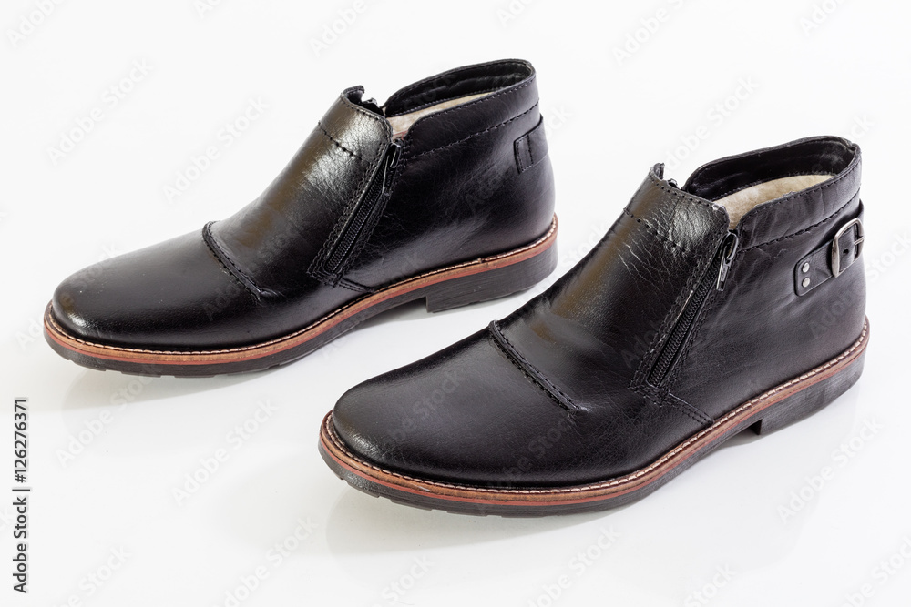 Black leather shoes on white background
