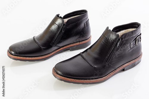 Black leather shoes on white background