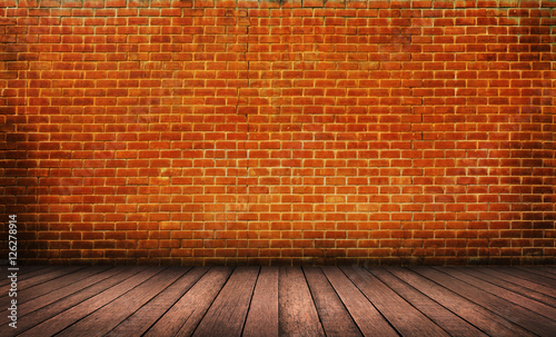 Wood floor with red brick wall background