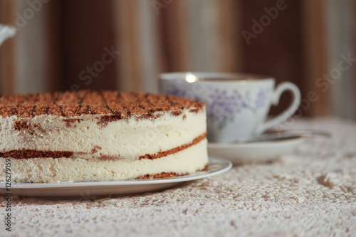 delicious cake on a plate and tea