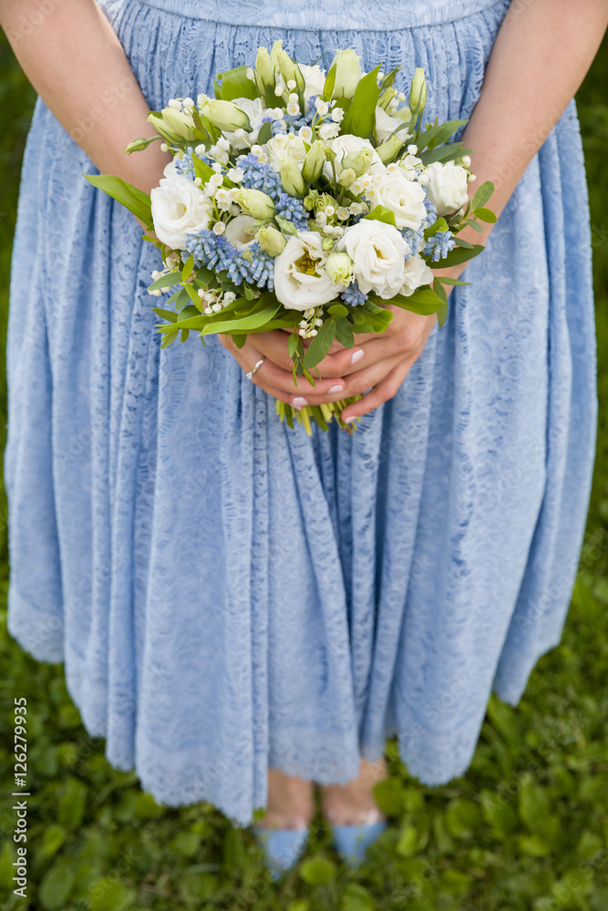 Top view on woman in blue dress holding beautiful wedding bouquet of flowers. Bride.