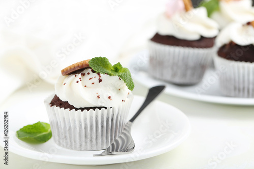 Chocolate cupcakes on a white wooden table