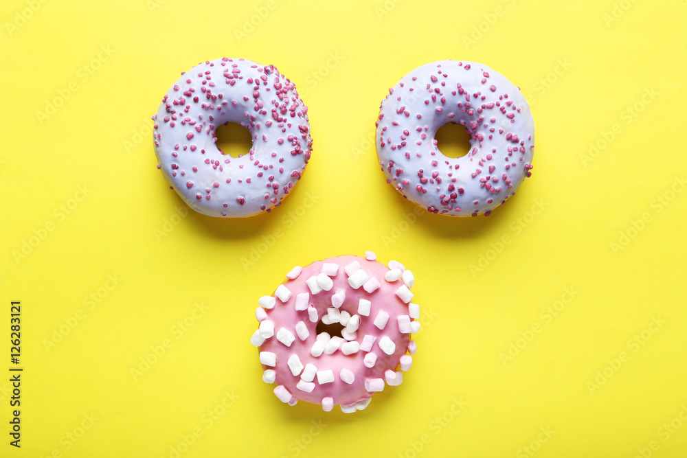 Sweet donuts on paper background