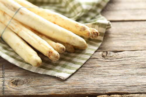 Fresh white asparagus on a grey wooden table