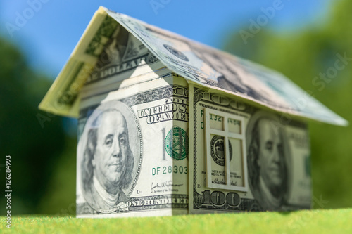 Cottage made of dollar banknotes, housing loan. Think green.