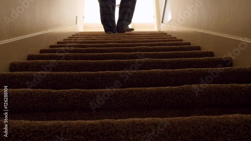 A man walks down house basement stairs