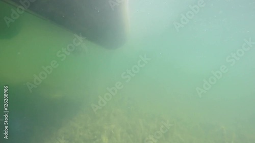 Underwater shot of a pontoon boat on lake photo